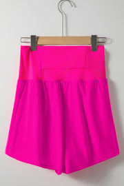 a bright pink shorts hanging on a hanger
