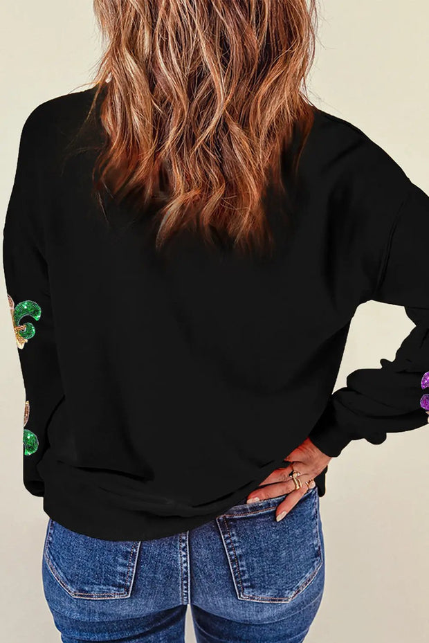a woman with long hair wearing a black shirt and jeans