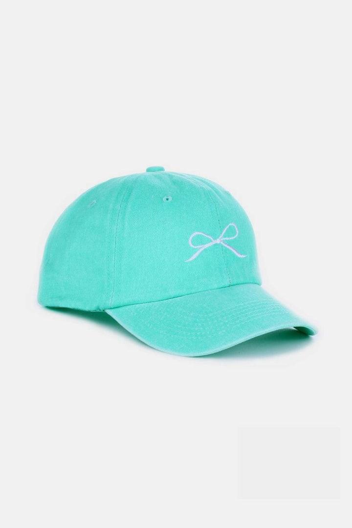 a turquoise hat with a white bow on it