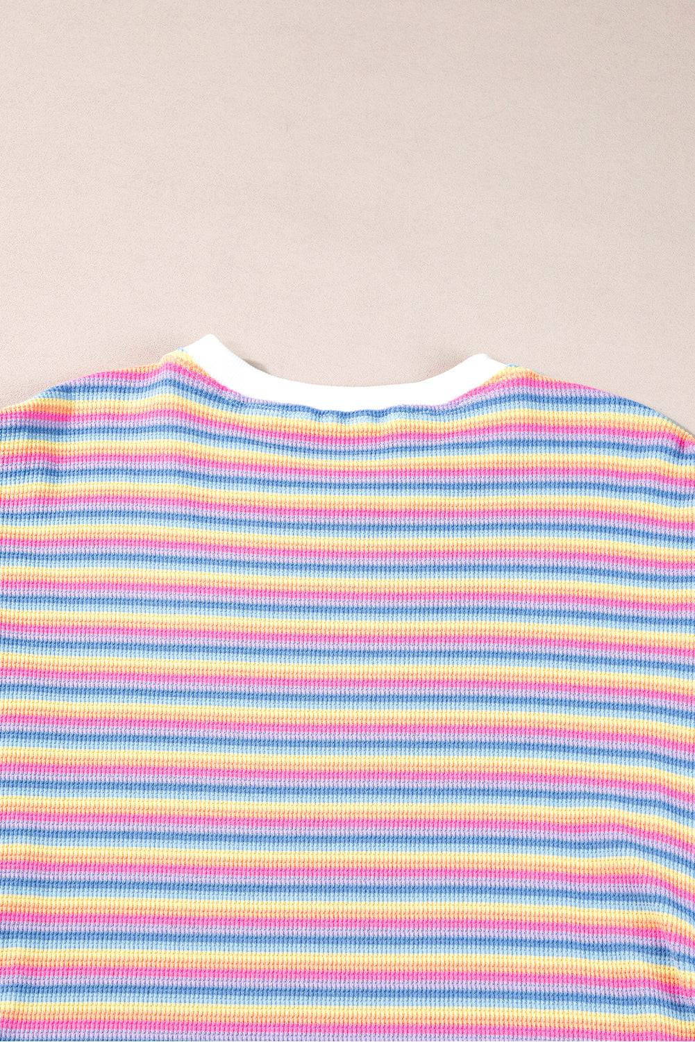 a striped shirt laying on top of a table