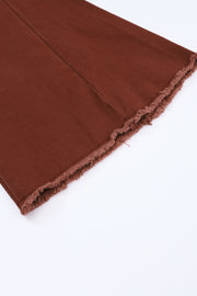 a close up of a brown cloth on a white surface