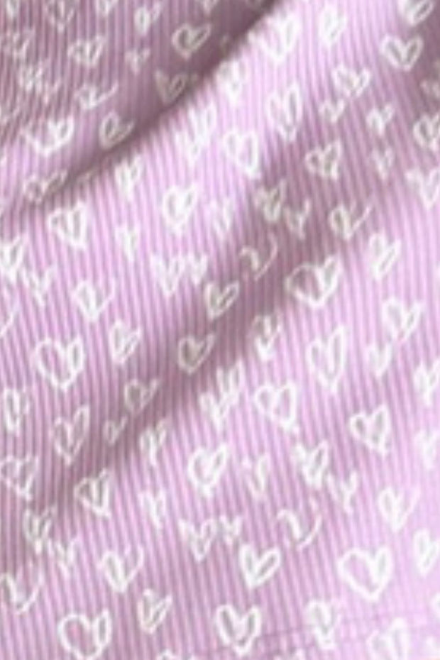 a close up of a pink shirt with hearts on it