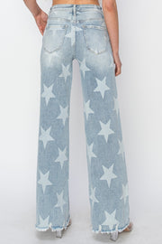 a woman is wearing a pair of blue jeans with white stars on them