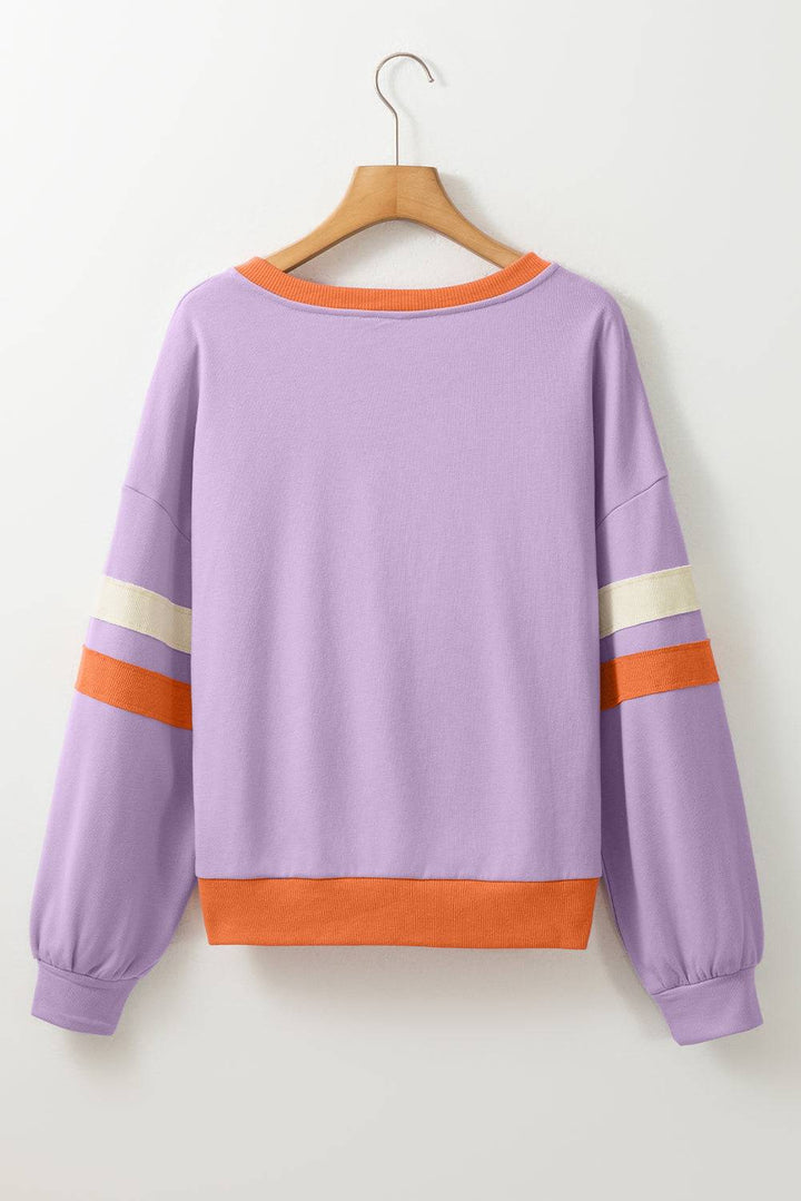 a purple sweatshirt with an orange stripe on the sleeves