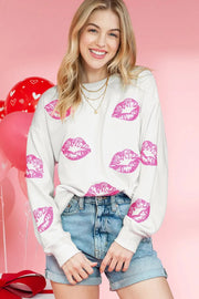 a woman posing for a picture wearing a white sweater with pink lipstick on it