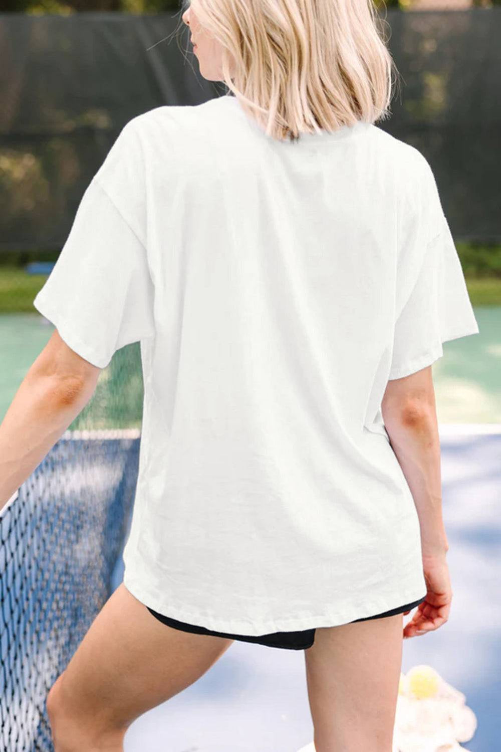 a woman standing on a tennis court holding a racquet