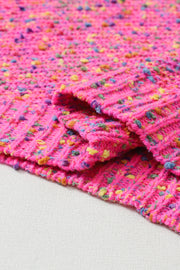 a close up of a knitted blanket on a table