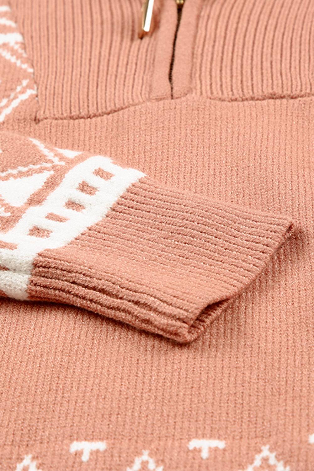 a pink sweater with a white design on it