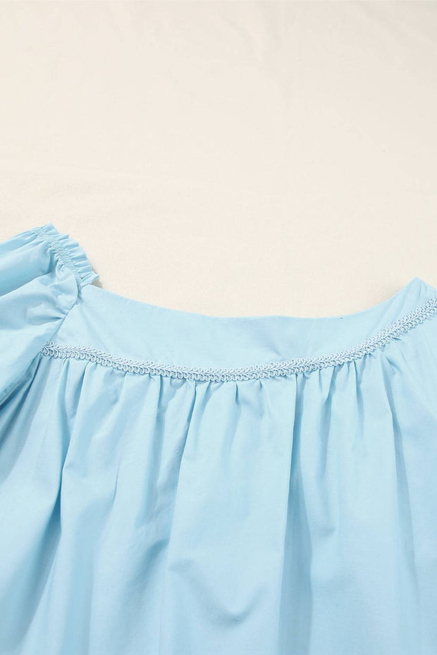a close up of a blue dress on a white surface