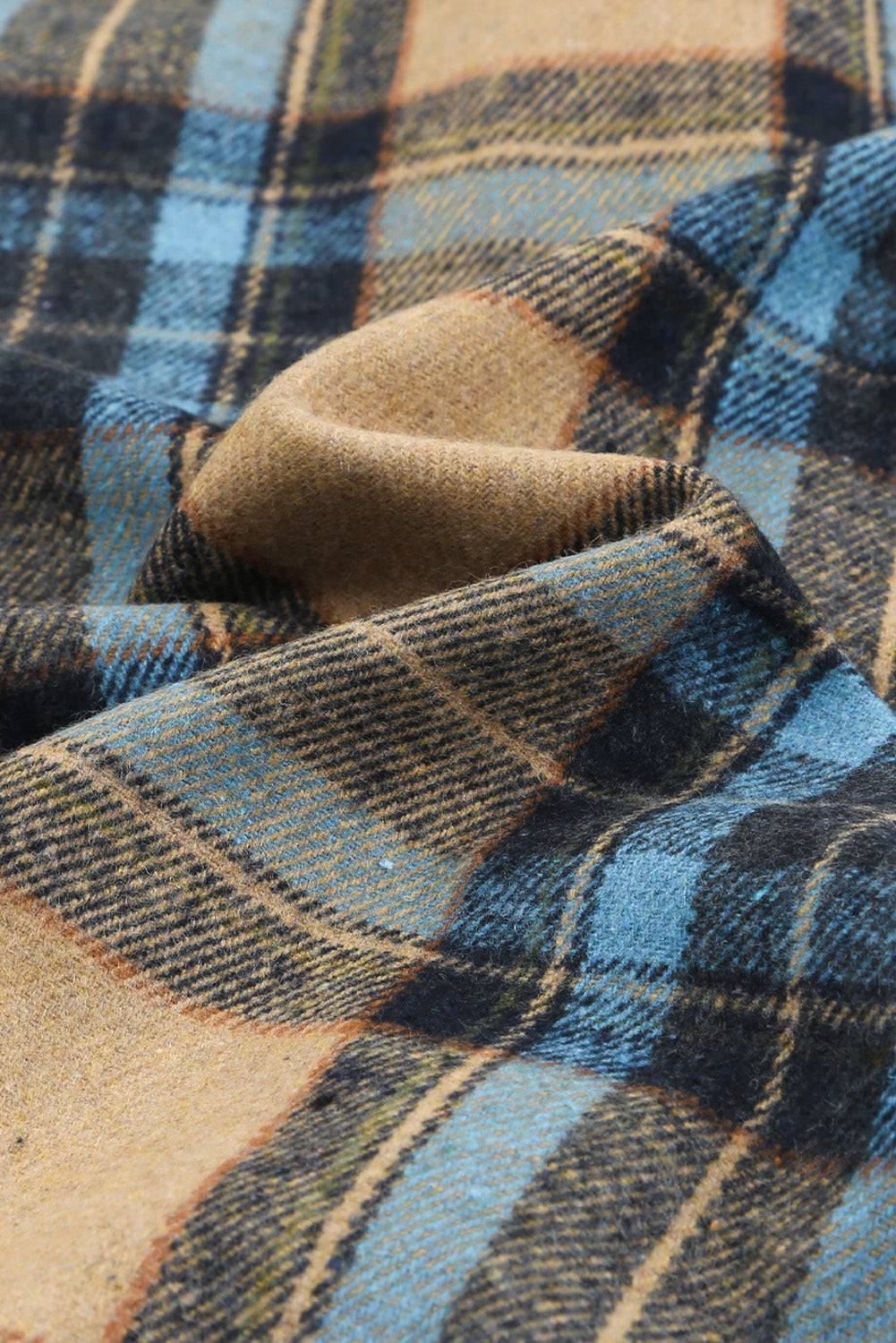 a close up of a blue and brown plaid shirt