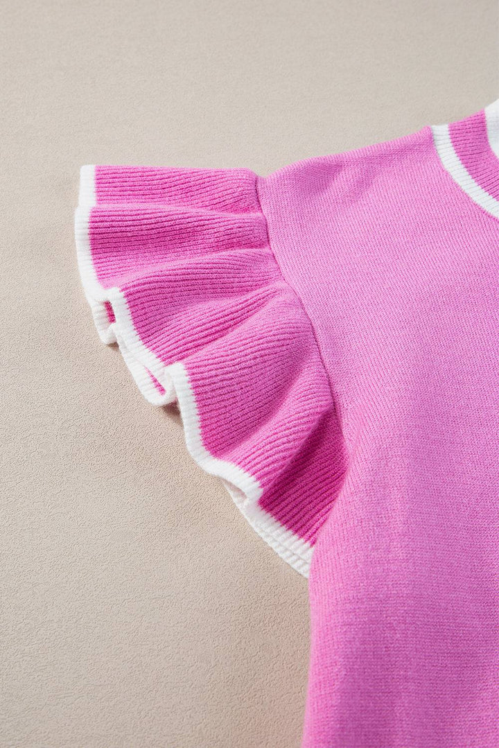 a close up of a pink sweater with white trim