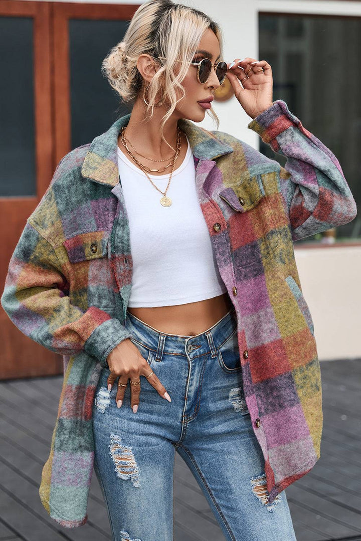 a woman wearing ripped jeans and a plaid jacket