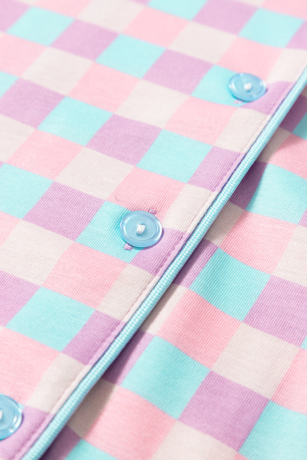 Close-up of buttons and piping on Purple Checkered Pattern Short Sleeve Pajamas Set, adding a stylish touch to this comfy sleepwear.