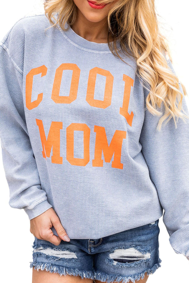 a woman wearing a sweatshirt that says cool mom