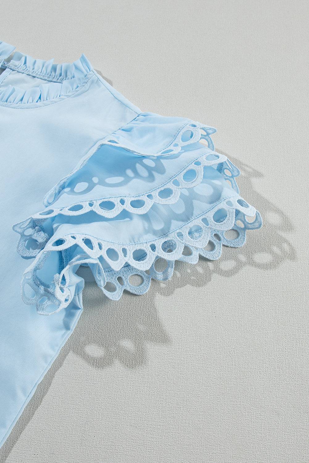 a blue dress laying on top of a white surface