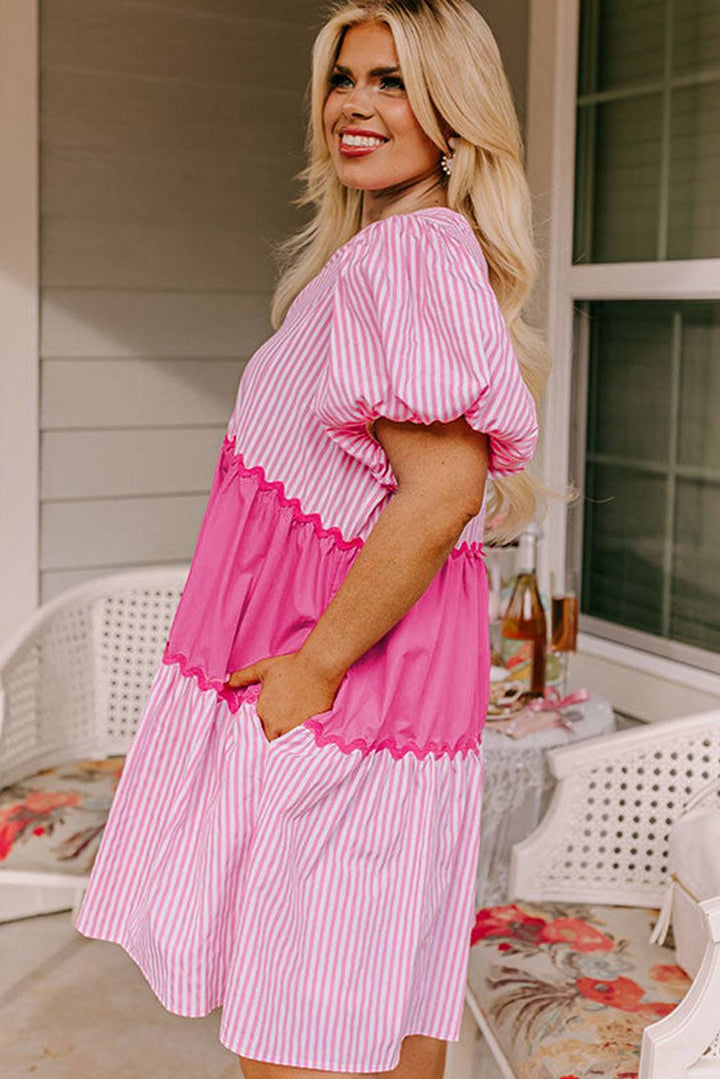 a woman in a pink and white striped dress