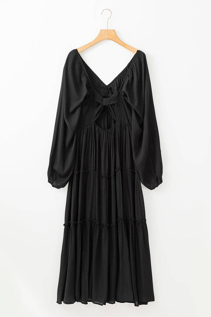 a black dress hanging on a hanger