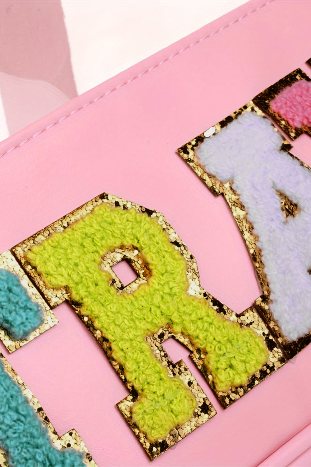 a close up of a pink purse with letters on it