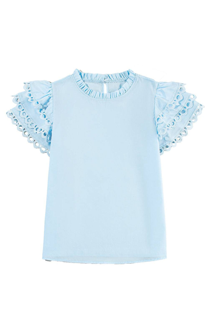 a baby blue top with ruffles on the sleeves