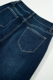 a pair of dark blue jeans on a white surface