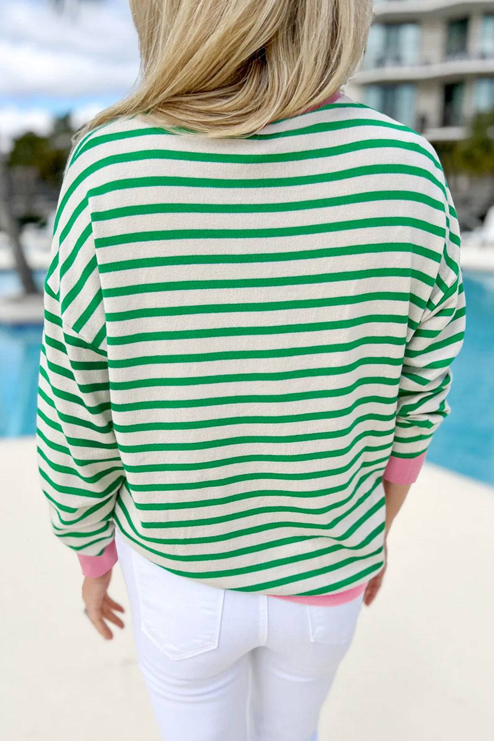 a woman wearing a green and white striped top