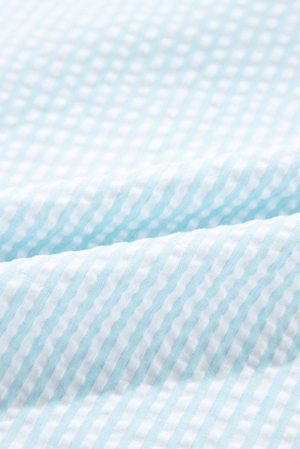 a close up of a blue and white checkered fabric