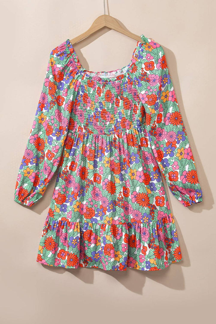 a colorful floral dress hanging on a hanger