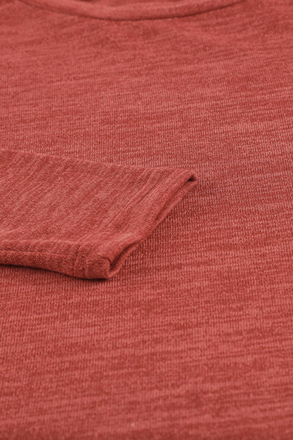 a close up of a red t - shirt with a folded pocket