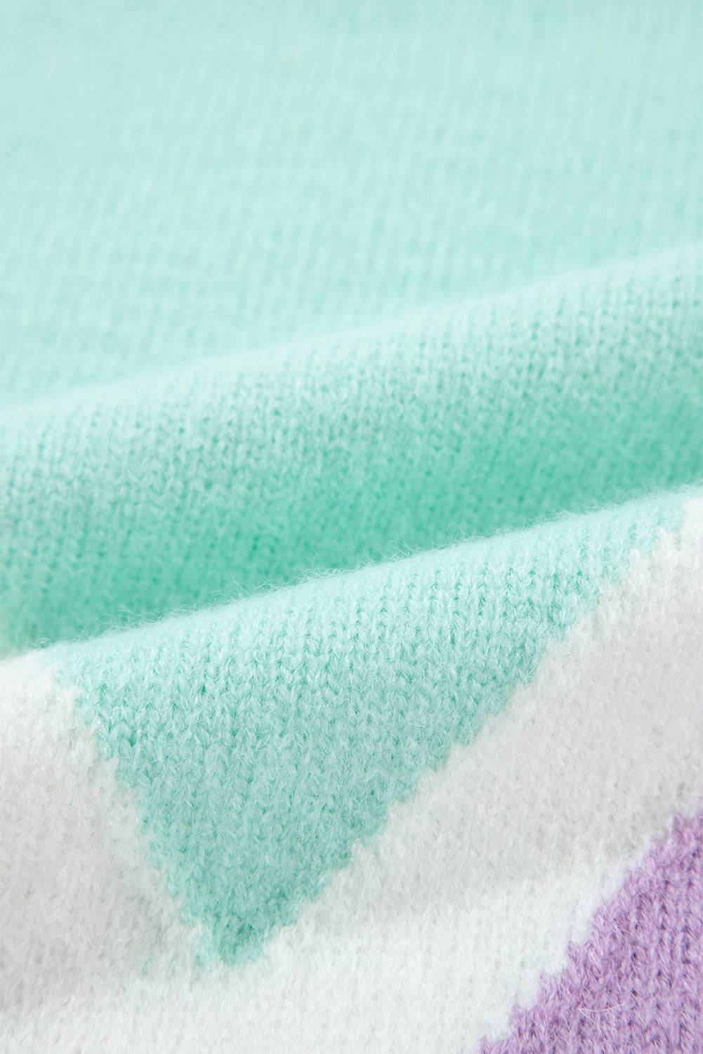 a close up of a blanket with a blue, purple, and green color scheme