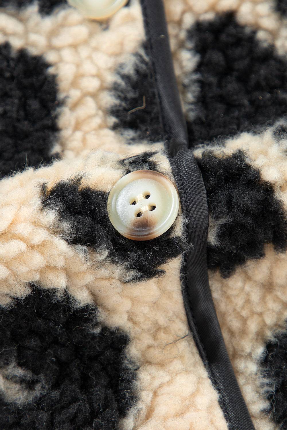 a close up of a button on a coat