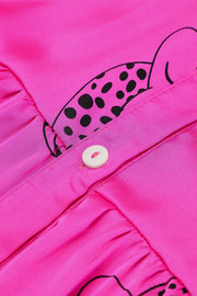a close up of a button on a pink shirt