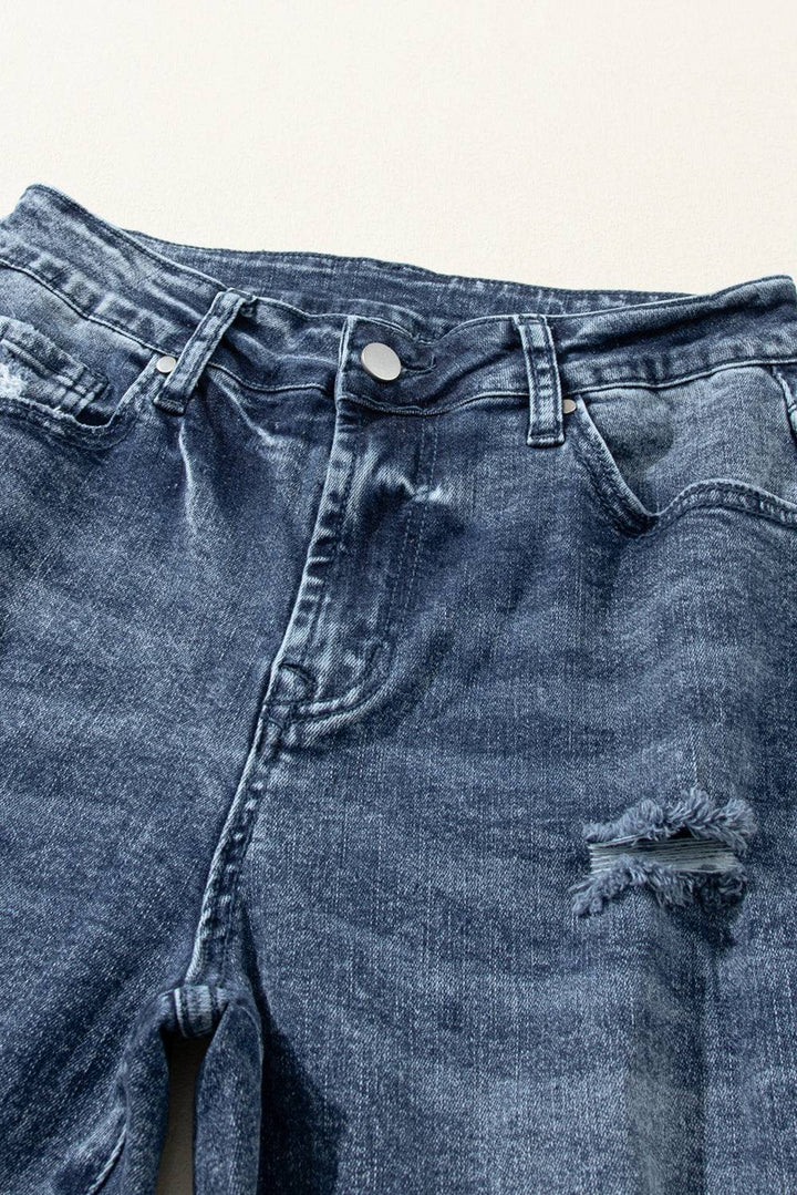 a pair of blue jeans with holes in them