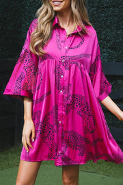 a woman in a pink shirt dress posing for a picture