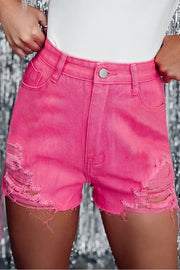 a woman wearing pink shorts and a white shirt