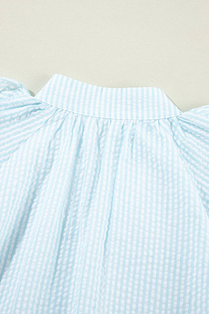 a close up of a blue and white striped dress