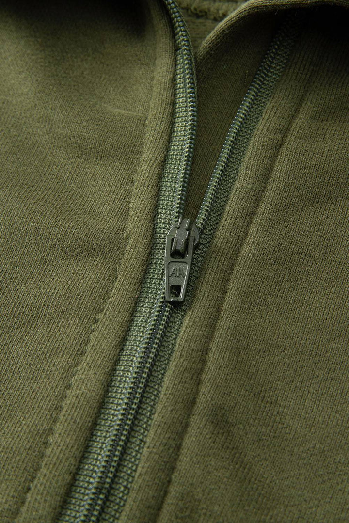 a close up of a zipper on a green jacket