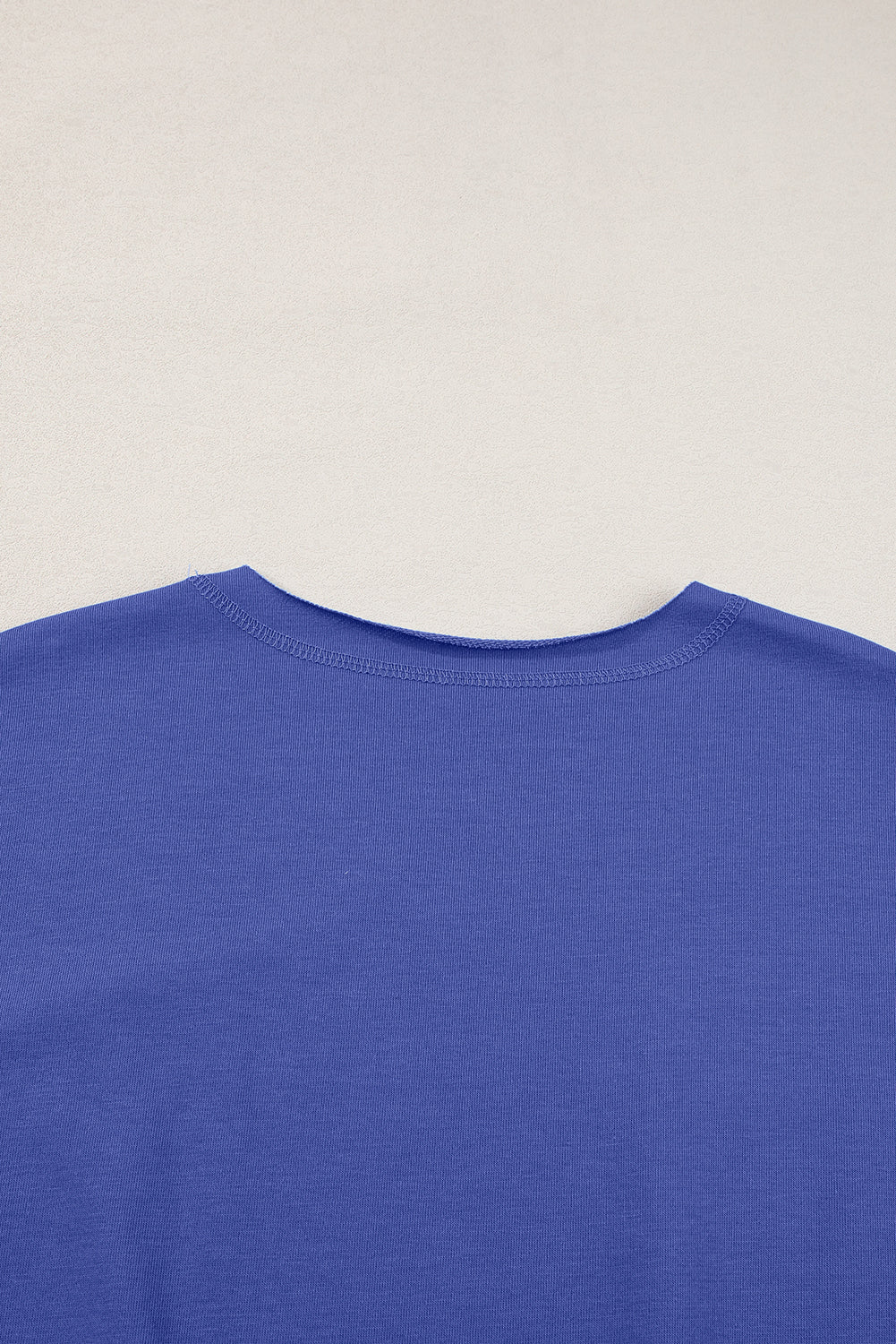 a close up of a blue shirt on a white background