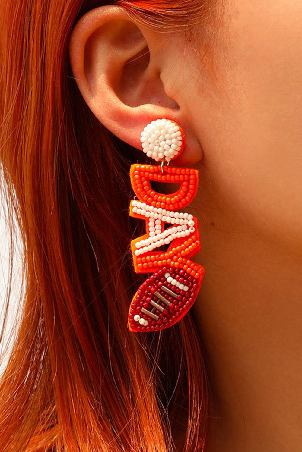 a close up of a person wearing a pair of earrings