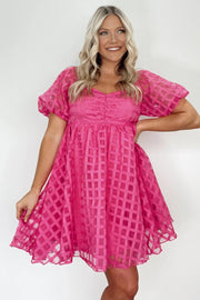 a woman in a pink dress posing for a picture