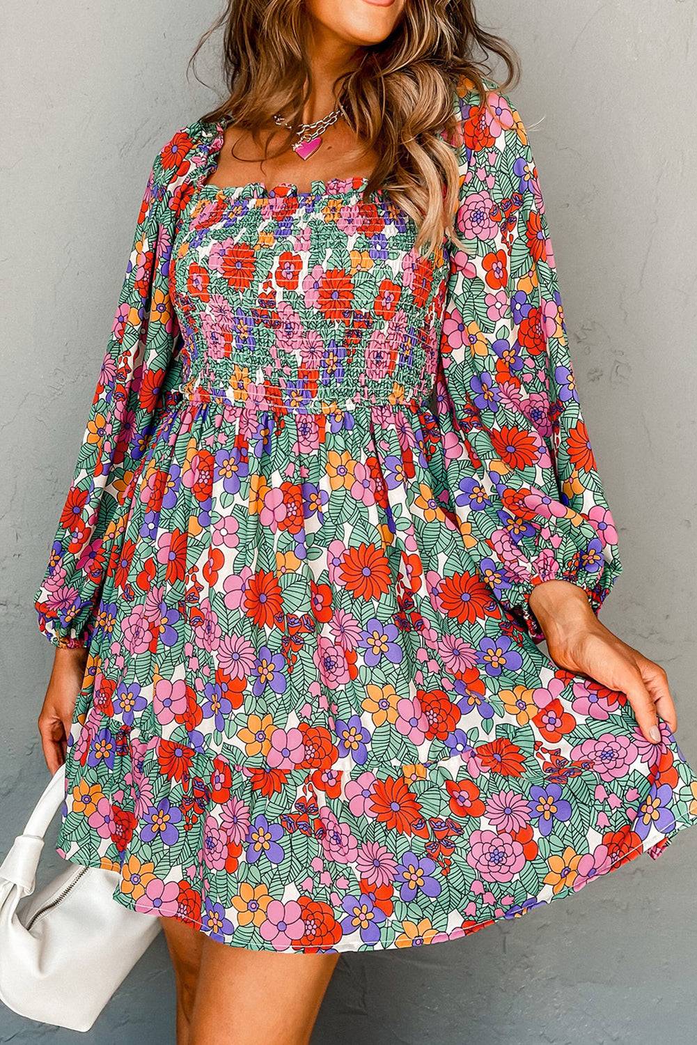 a woman in a floral dress posing for a picture