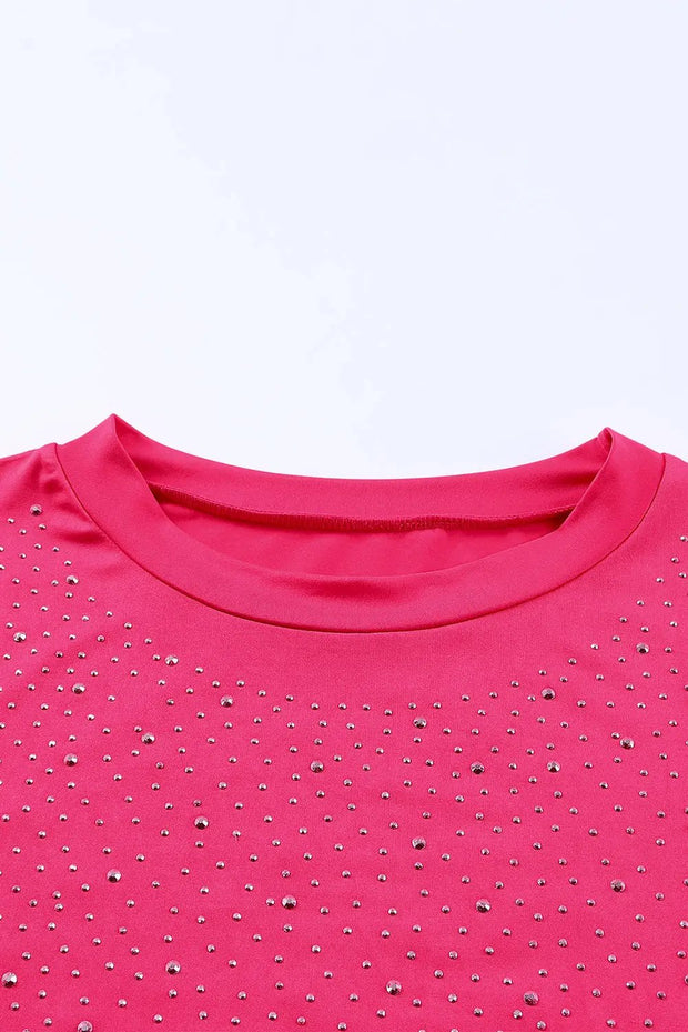 a pink t - shirt with silver sequins on it
