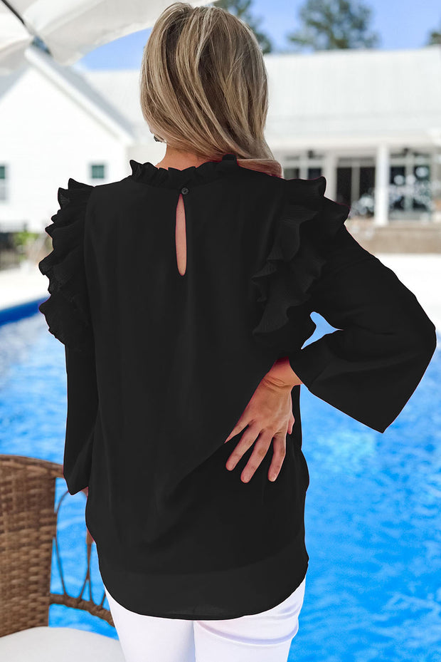a woman standing in front of a pool wearing a black top