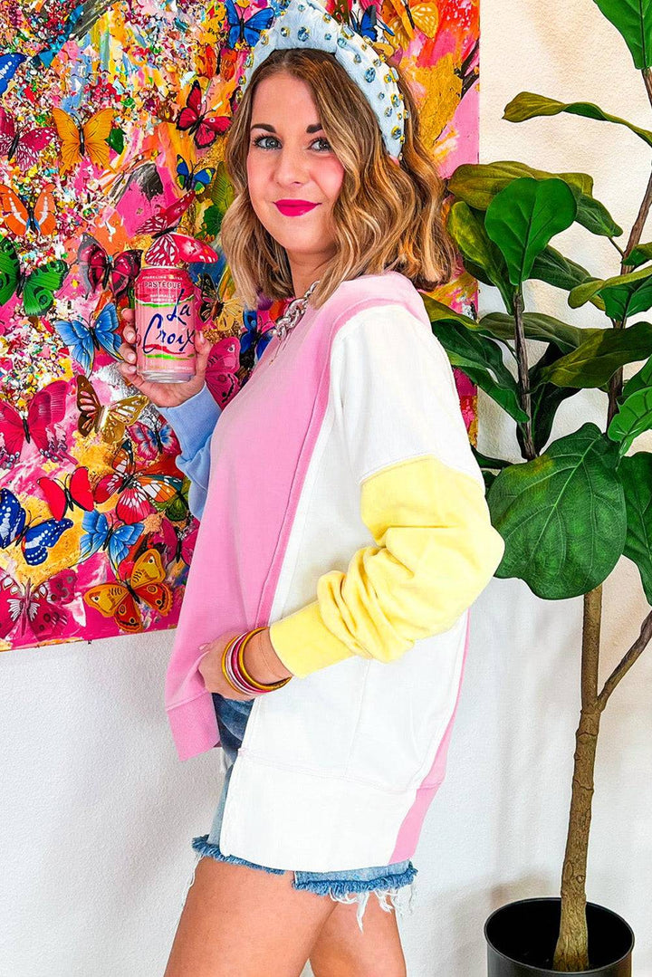 a woman standing in front of a colorful painting