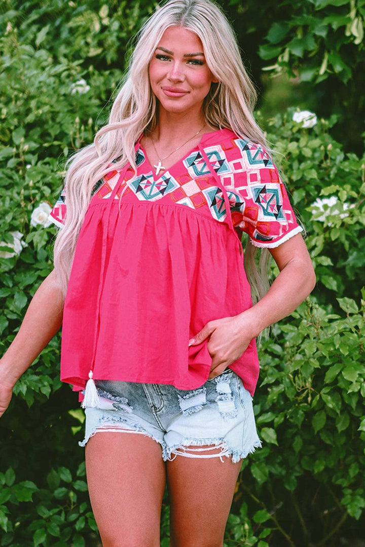 a woman in shorts and a top posing for a picture