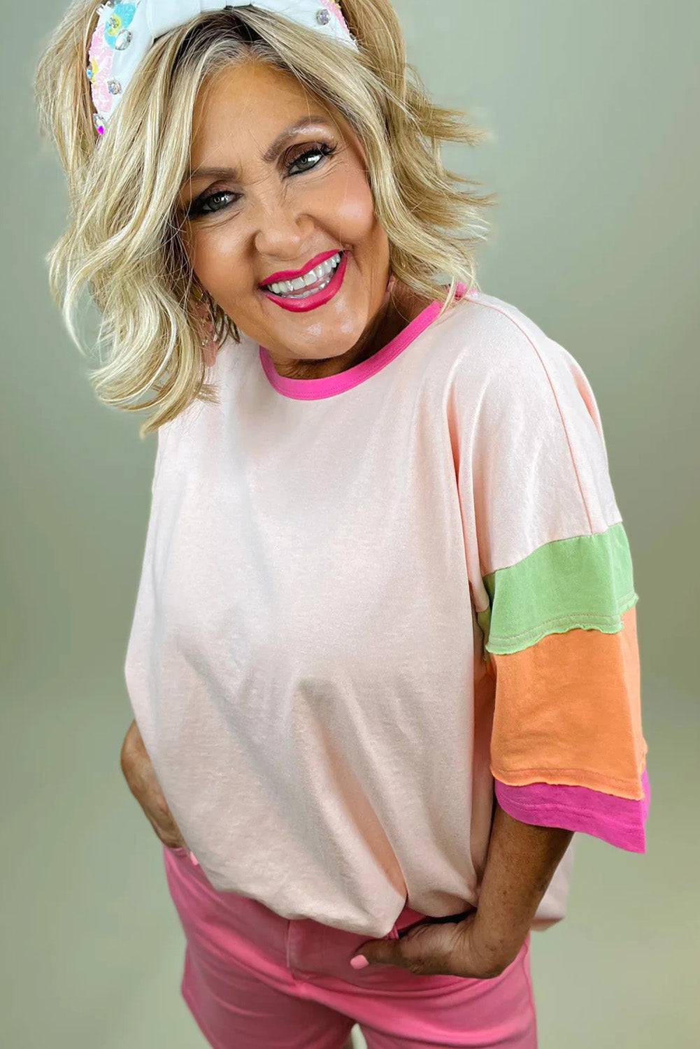 a woman with blonde hair wearing a pink shirt and pink pants