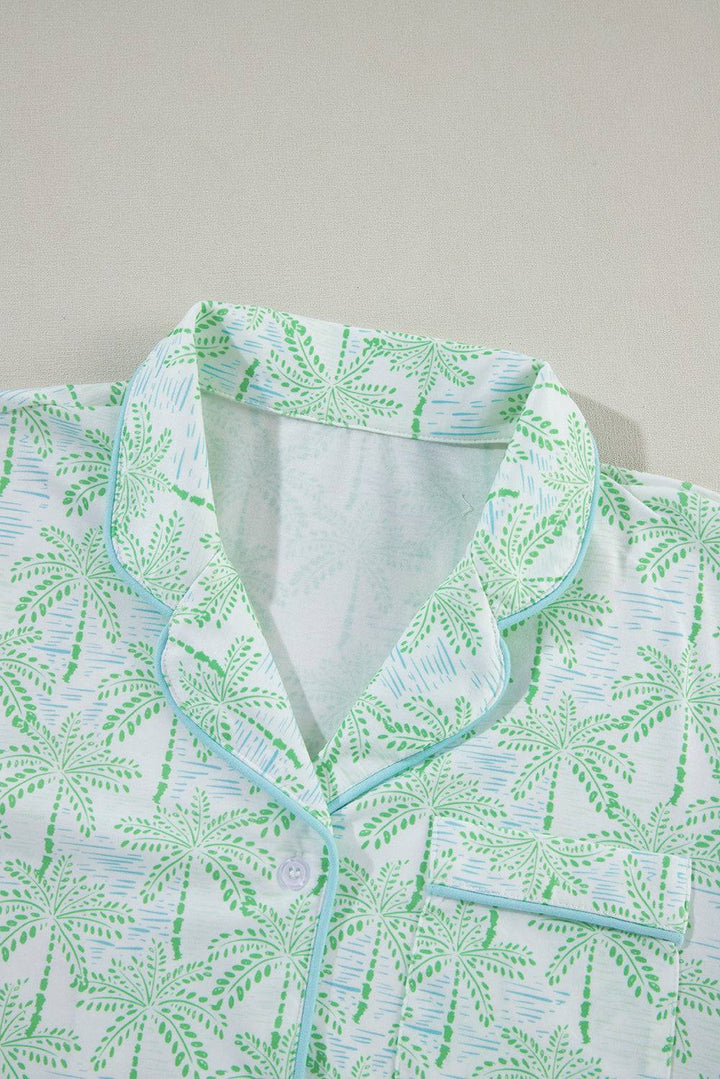 a white shirt with green leaves on it