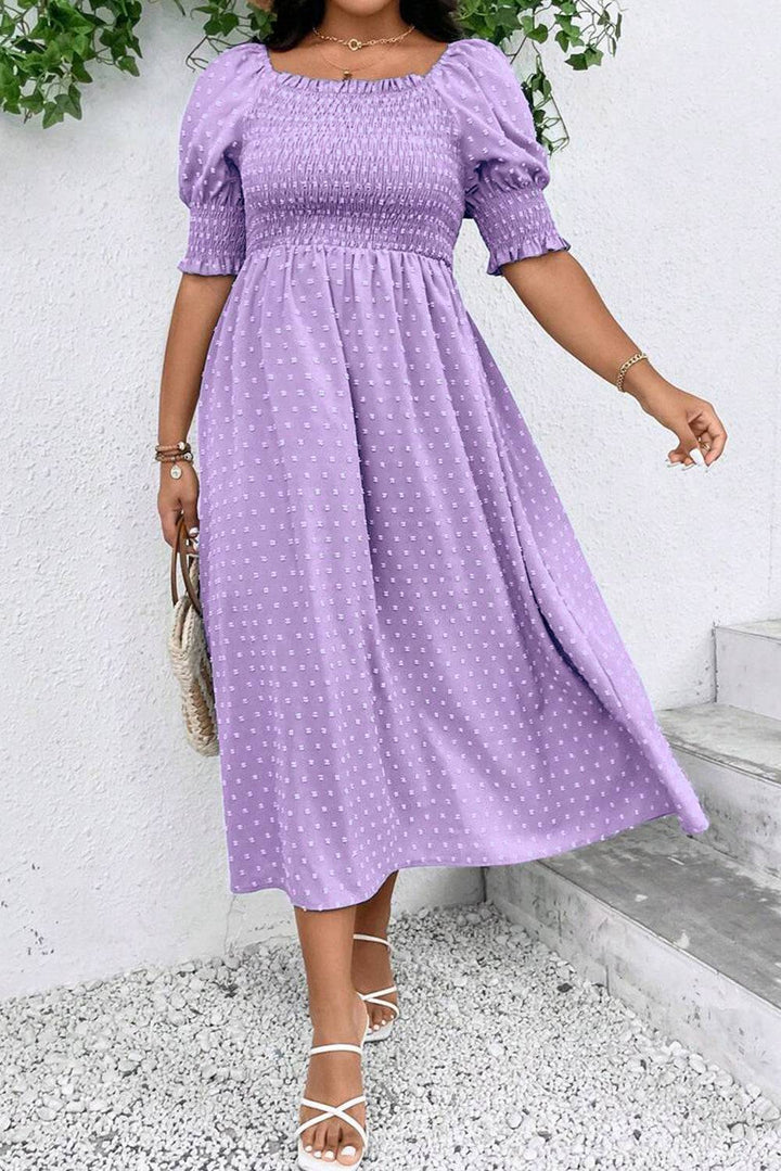 Wisteria Swiss Dot Smocked Frilled Neckline Short Sleeve Plus Size Dress in light purple with A-line silhouette, styled with white sandals.