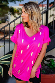 a woman wearing a pink lightning t - shirt