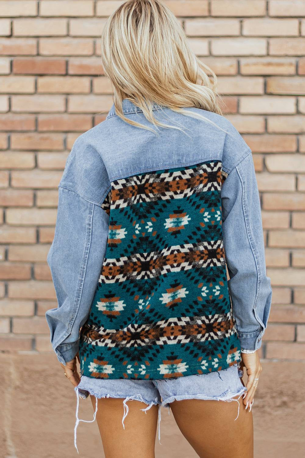 a woman wearing a jean jacket and shorts