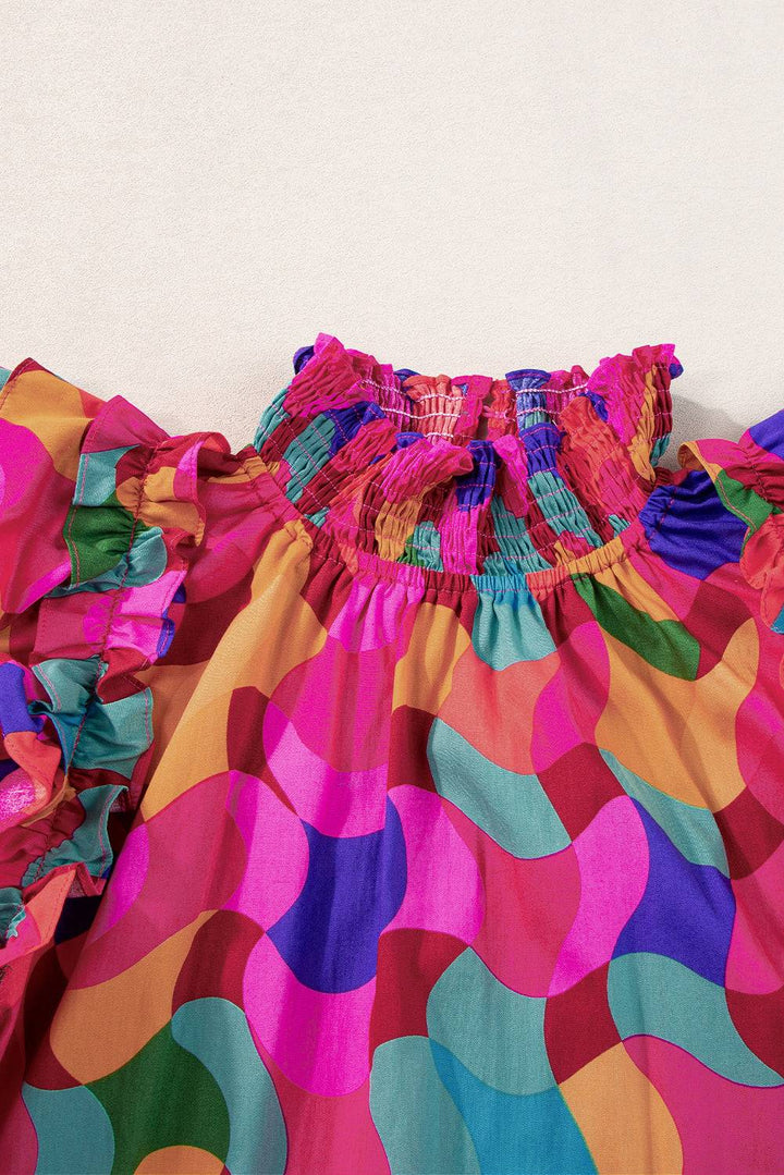 a close up of a colorful dress on a white wall